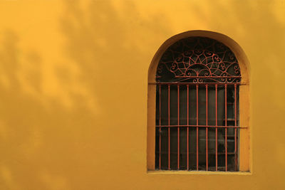 Close-up of yellow window on building