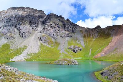 Scenic view of lake and mountains against sky