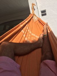 Low section of man sitting on hammock