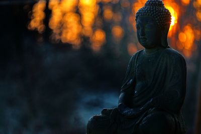 Statue of buddha against blurred background