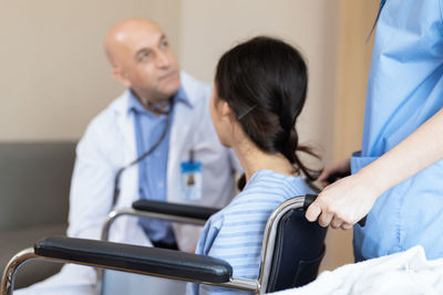 Doctor examining patient at clinic