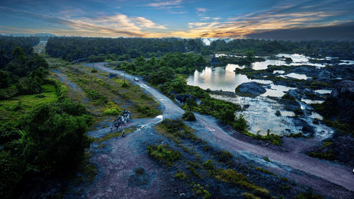 High angle view of river amidst trees against sky