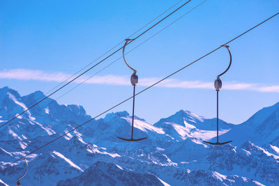 Snow covered mountains against blue sky