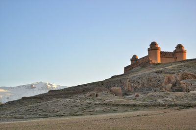 View of landscape against clear blue sky