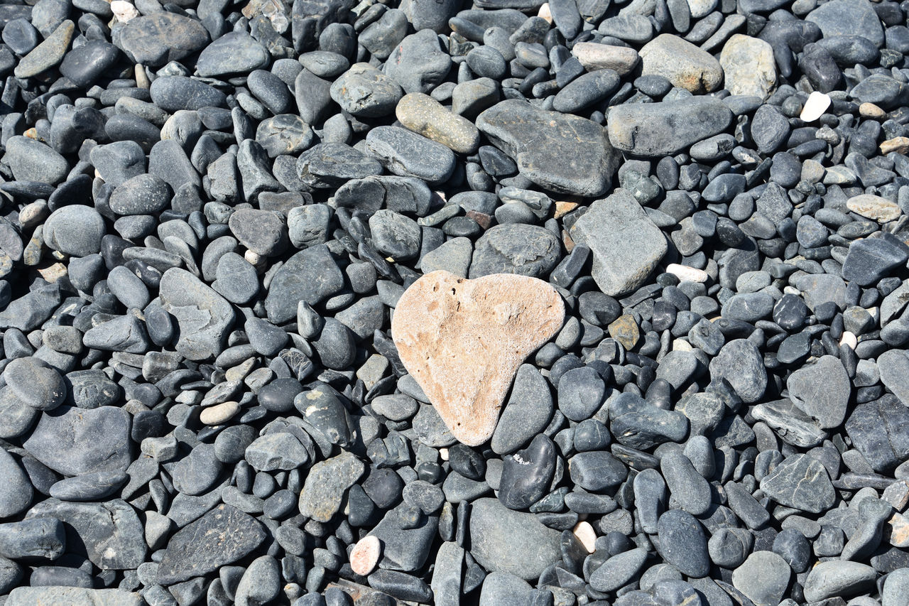 soil, rock, asphalt, stone, rubble, gravel, full frame, backgrounds, road surface, no people, textured, large group of objects, high angle view, day, heart shape, pebble, abundance, nature, cobblestone, gray, wall, outdoors, flooring, stone wall, directly above, positive emotion, love, close-up, emotion, shape, pattern, rough, land