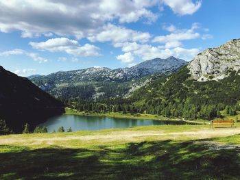 Scenic view of lake and mountains against sky