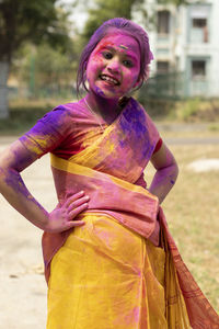 Portrait of woman standing on purple outdoors