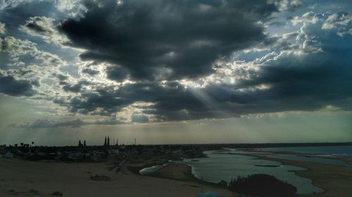 Scenic view of sea against storm clouds