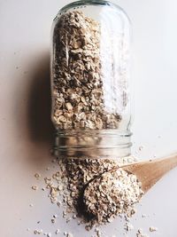 Close-up of oatmeal in jar on white background