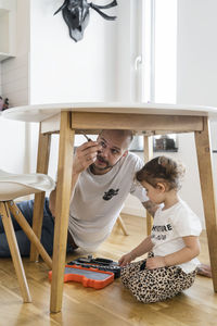 Father and daughter assembling table