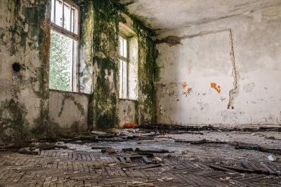 Damaged window in abandoned house