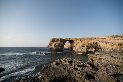 Scenic view of azure window on sea against clear sky