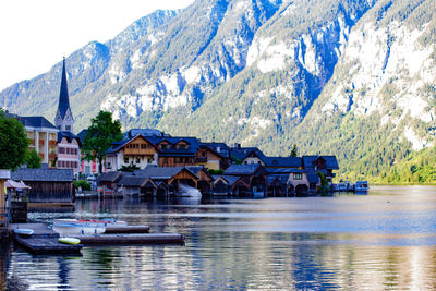 Boats moored on lake against mountains