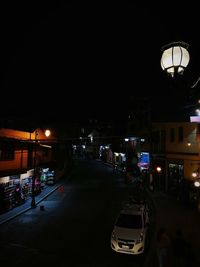 Illuminated street lights in city at night