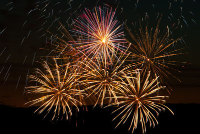 Low angle view of firework display at night