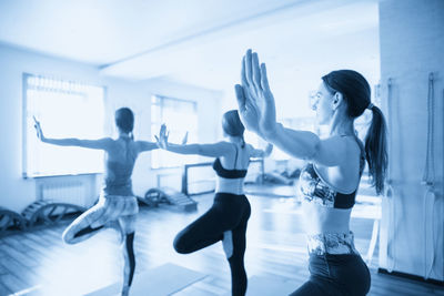 Rear view of woman exercising in gym