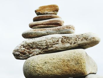 Close-up of stone stack against white background