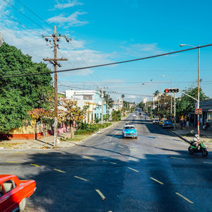 Cars on road against sky in city