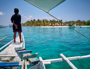 Rear view of man standing in swimming pool