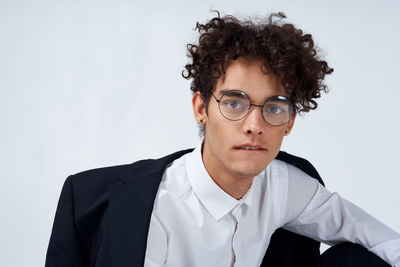 Portrait of young man against white background