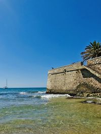 Scenic view of sea against clear blue sky