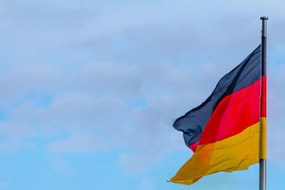 Low angle view of flag against sky