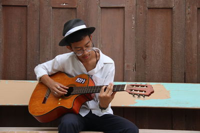 Full length of man playing guitar