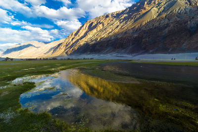 Scenic reflection of mountains in calm lake