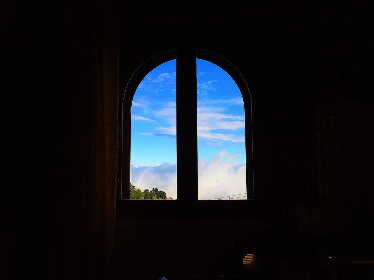 SILHOUETTE ARCH WINDOW AGAINST SKY SEEN THROUGH GLASS