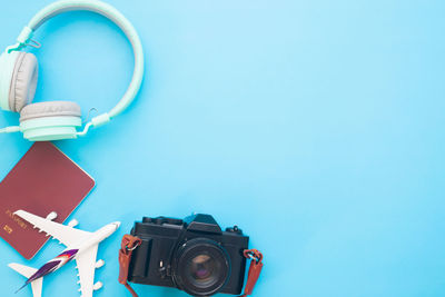 High angle view of camera on table against blue background