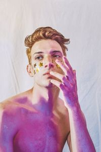 Portrait of young man holding purple