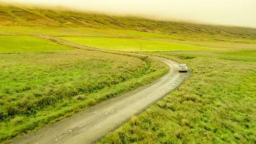 Country road amidst field