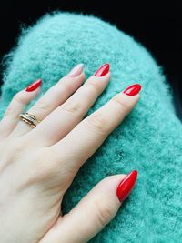 Close-up of woman hand on red finger