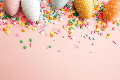 High angle view of multi colored candies against white background