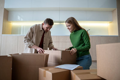 Side view of woman holding box