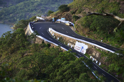 High angle view of road amidst trees and mountains