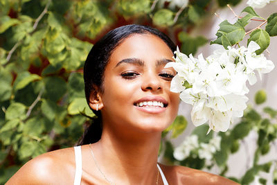 Cuban young woman among flowers in a garden in havana - cuba