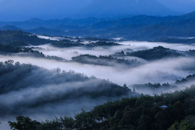 High angle view of trees and mountains against sky