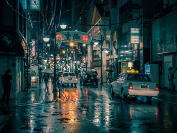 Cars on wet street at night