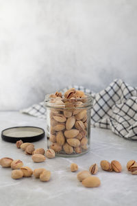 Close-up of pistachio  in jar on table