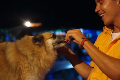 Close-up of hands holding dog