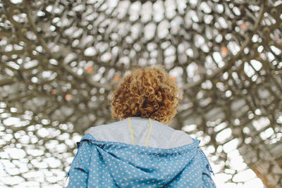 Rear view of young woman standing in gazebo