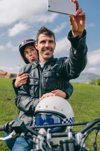 Portrait of smiling young man using mobile phone