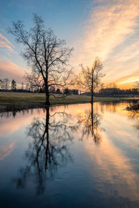 Scenic view of lake against sky at sunset