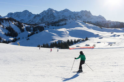 People skiing on snowcapped mountain