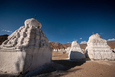 View of rock formations against clear blue sky