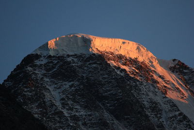 Low angle view of volcanic mountain against clear sky