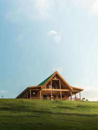 Scenic and peaceful isolated wooden modern cabin house landscape with blue sky and a moon