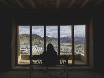 Silhouette woman sitting on bench in leh palace