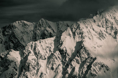 Scenic view of snow mountains against sky